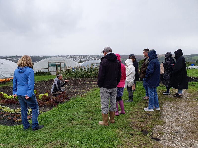 woman showing people composting techniques